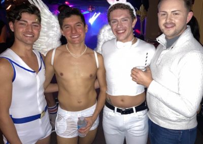 Four people dressed in white dressed in white costumes for Dunes Resorts Halloween 2021 Party