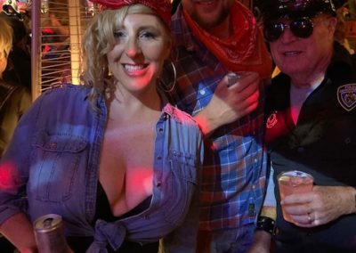 Three people dressed in costumes indoors at Dunes Resorts Halloween 2021 Party