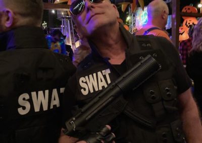 Two people dressed as SWAT workers at Dunes Resorts Halloween 2021 party.
