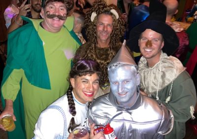 Five people dressed up in Wizard of Oz outfits pose for picture at Dunes Resorts Halloween 2021 party.