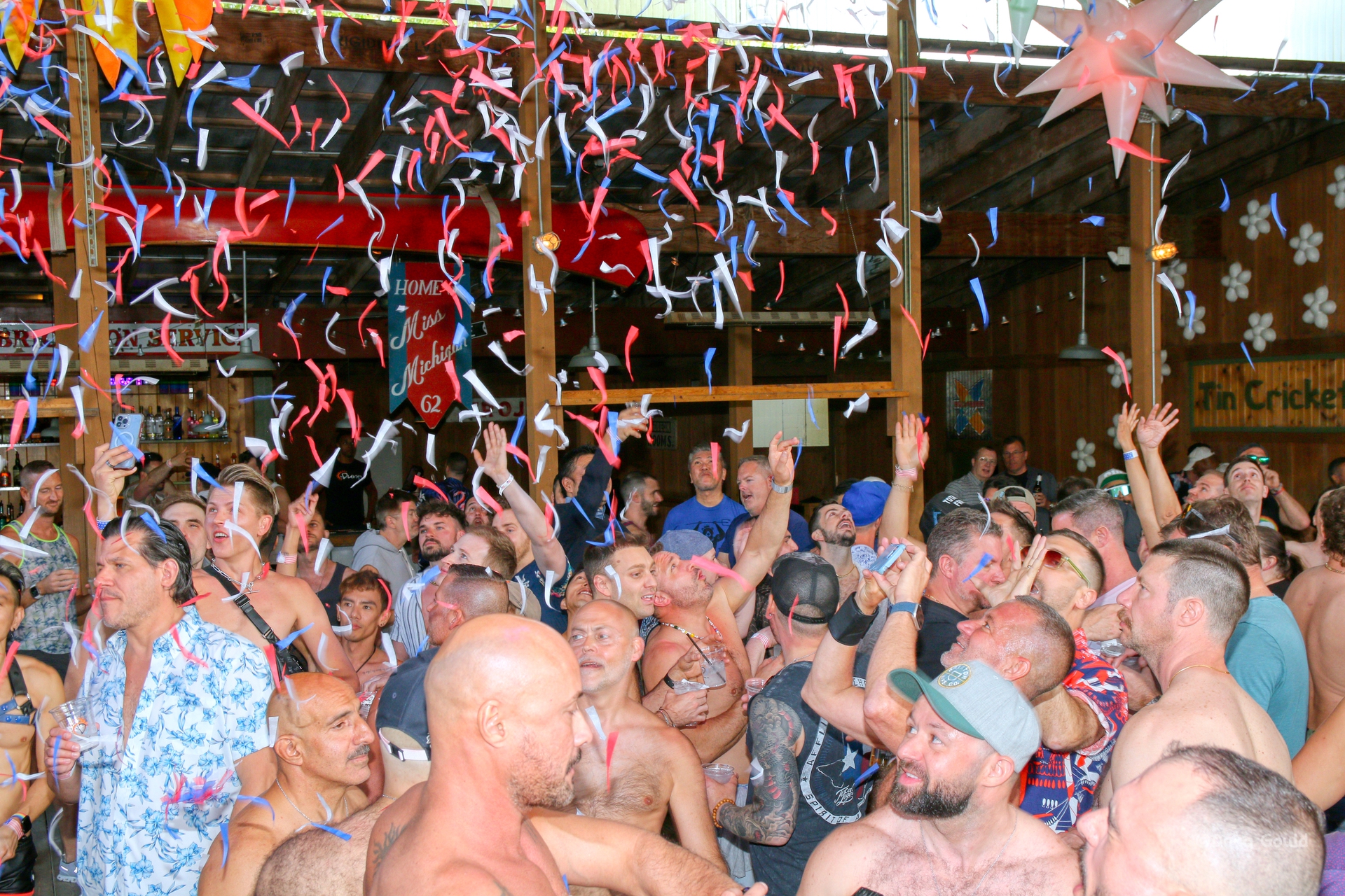 Dunes guest dancing to music with red, white, and blue confetti falling