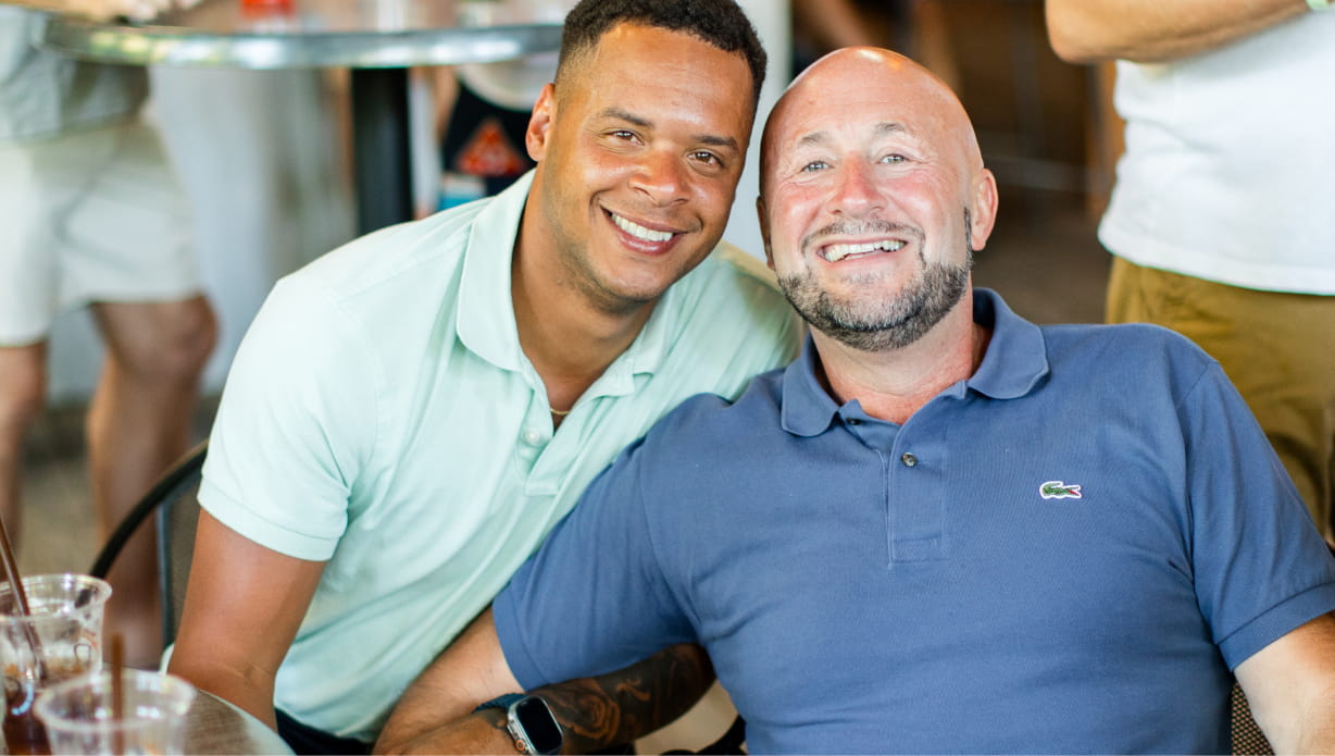 Two people smiling and posing on the Deck.